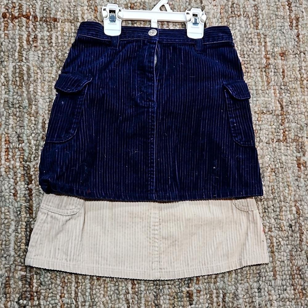 2 girls corduroy skirts. Zip front, side pockets